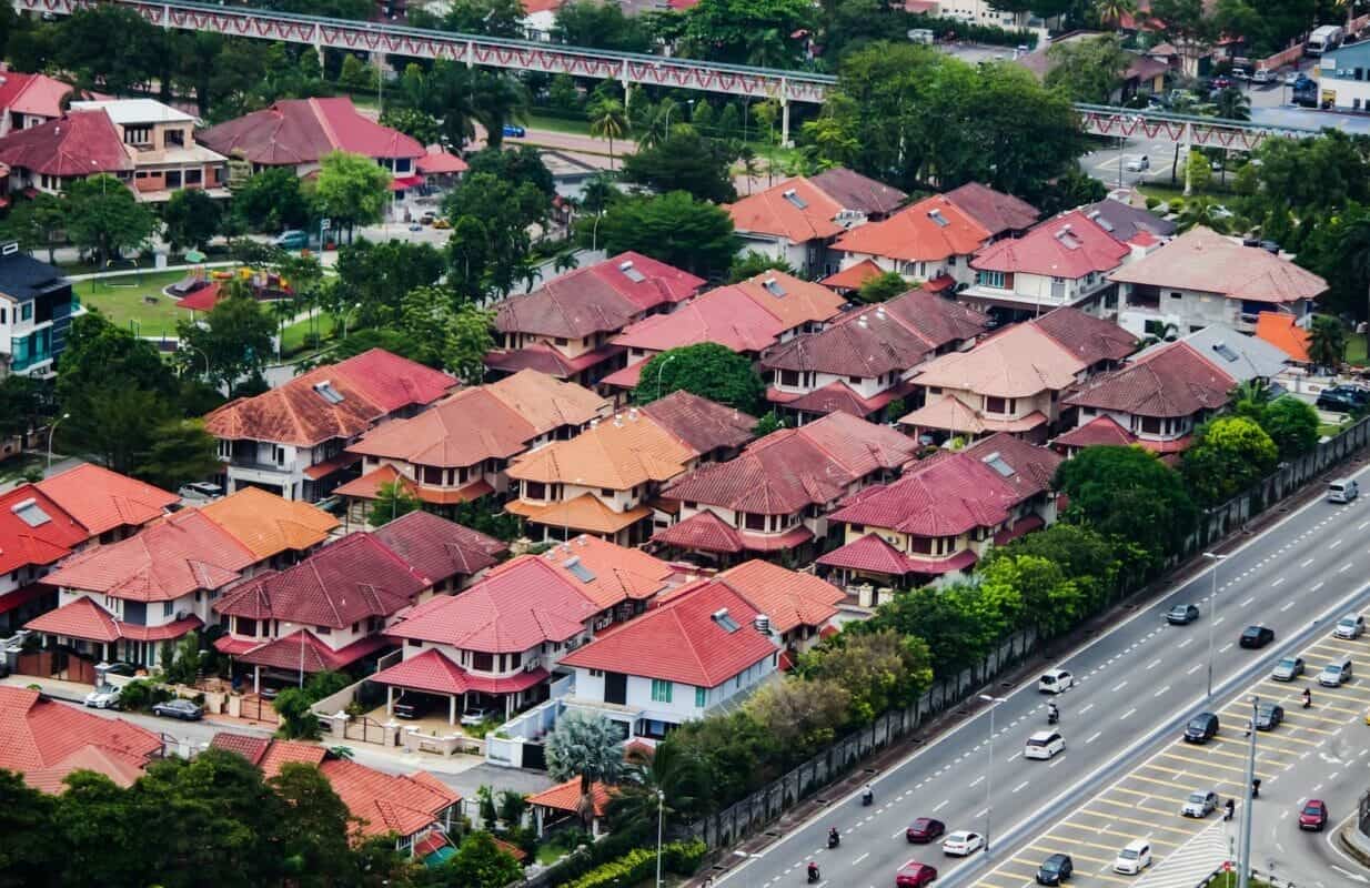 cars on road near houses during daytime